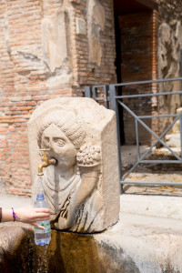 An ancient fountain still being used to dispense water.