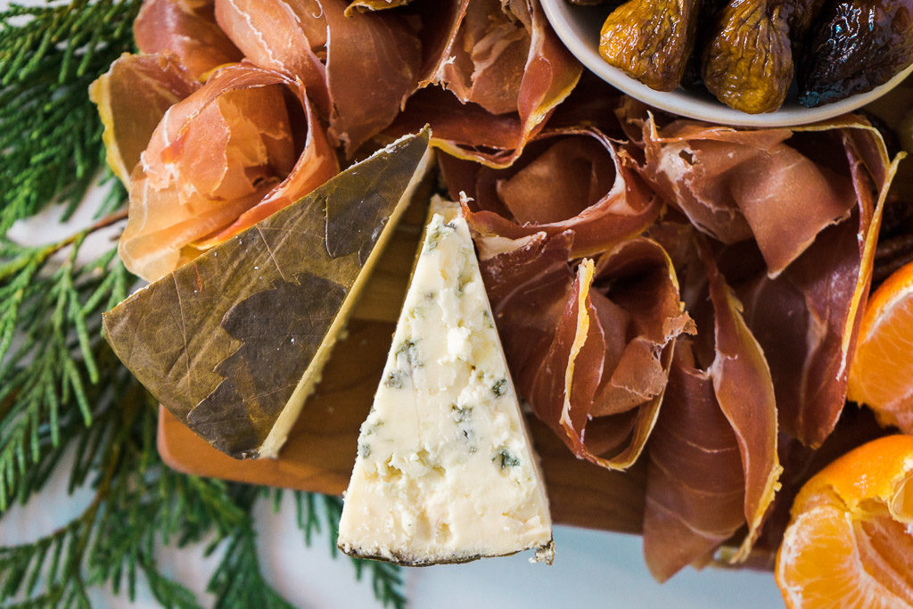 Rogue River Blue comes cloaked in pear brandy-infused grape leaves, and is available only around the holidays. One taste of it, and you will wish you got a bigger wedge. An unforgettable holiday cheese board with Cheese Plus. By Vero Kherian for misscheesemonger.com.